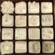 A box of white clay with various shapes and designs.