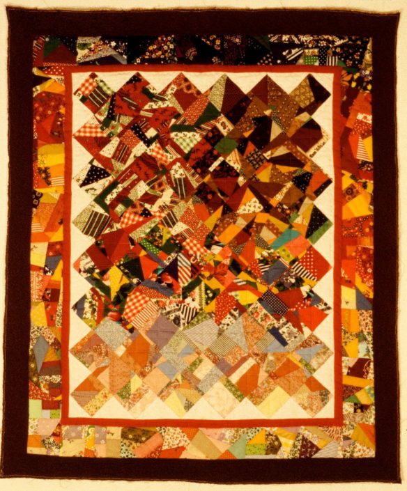 A colorful quilt with many different colors and shapes.