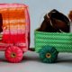 A toy train with two stuffed animals in it.